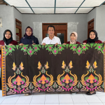 Penyerahan batik dari mahasiswa kepada Kepala Desa